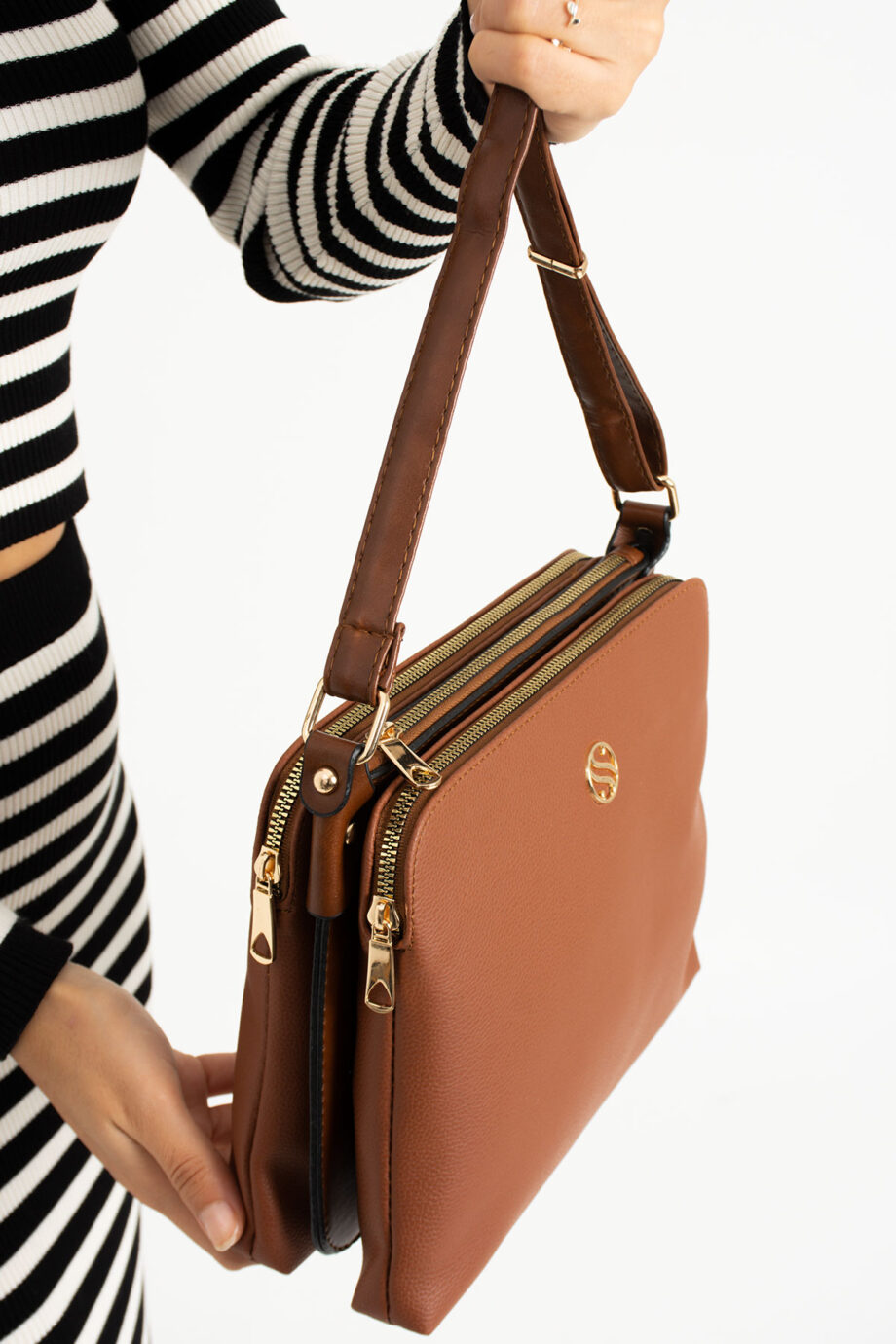 Tan Sanmorris 4-compartment crossbody bag styled with a fashionable outfit, highlighting its versatility for any occasion.